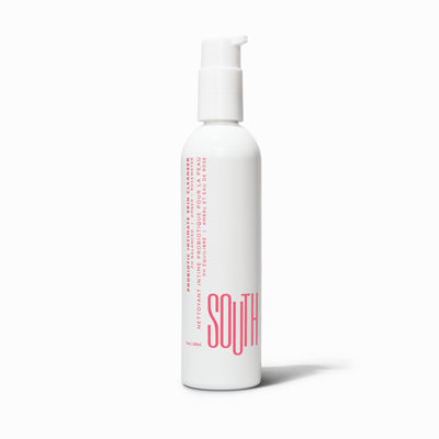 Bottle of SOUTH intimate cleanser, white bottle with pink writing