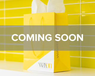 image of a yellow WAXON gift bag with a note that says "COMING SOON" for WAXON Laser + Waxbar's new Edmonton, Alberta location opening in 2024.