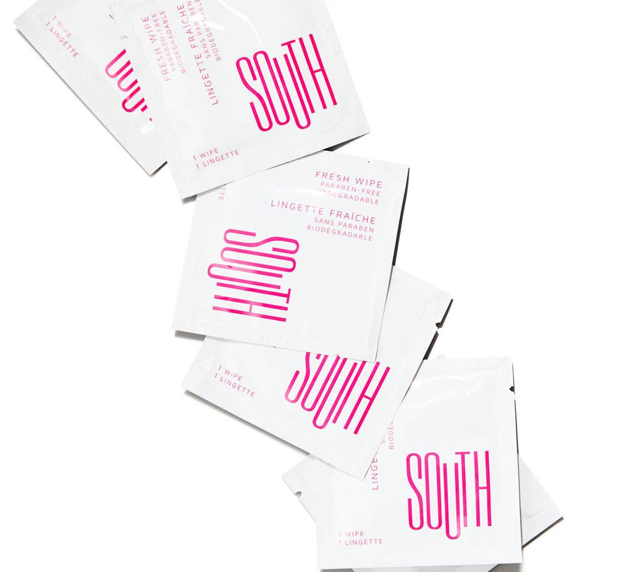 Multiple SOUTH intimate wipes laid out in a line and slightly overlapping each other.